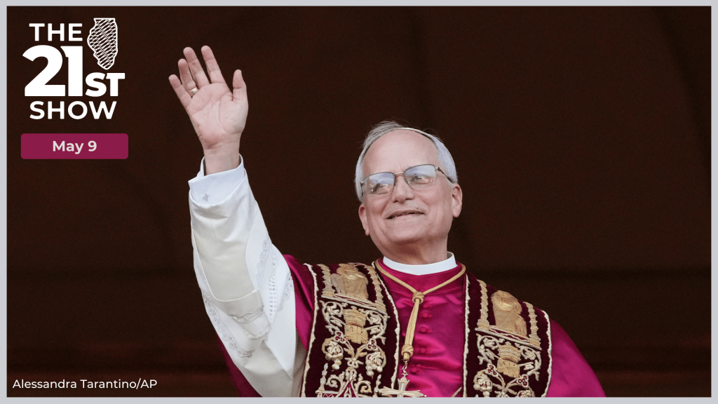 a gray-haired man in a white cassock, red cape and golden chasuble raising his right arm to wave at a crowd