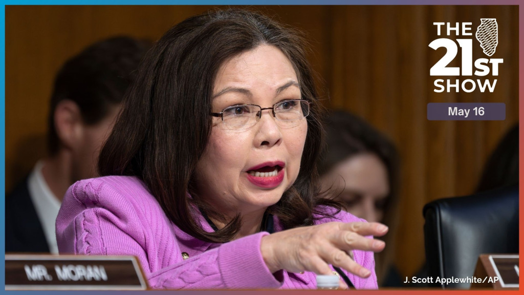Duckworth, wearing a pink blazer, is gesturing with her right hand as she speaks in a wood-paneled room