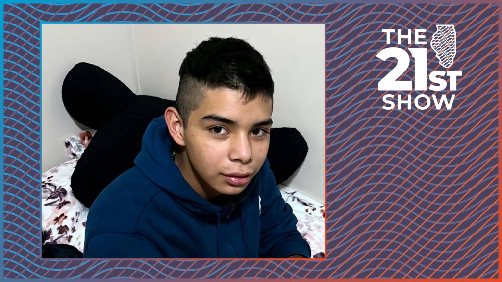 a teenager with dark hair wearing a navy blue hoodie is sitting on a bed