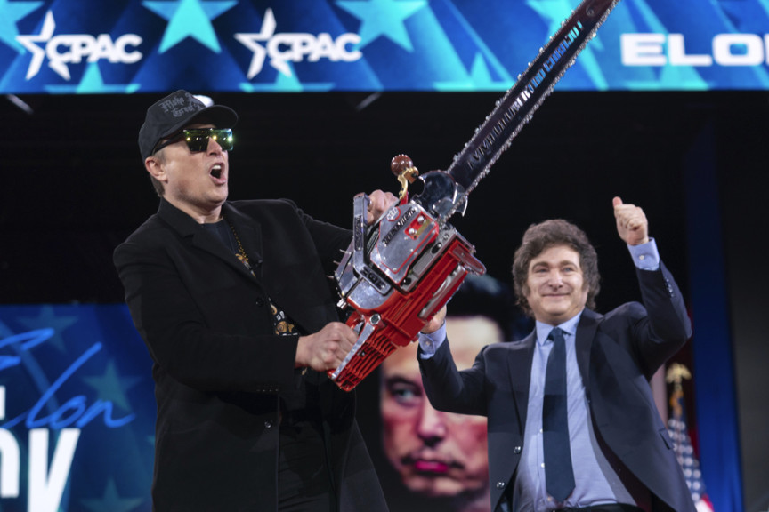 Elon Musk hold a chainsaw as he arrives to speak at the Conservative Political Action Conference, CPAC, at the Gaylord National Resort & Convention Center, Thursday, Feb. 20, 2025, in Oxon Hill, Md.