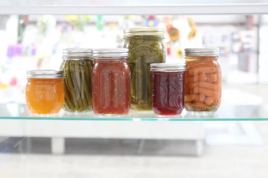 Colorful jars of fruit and vegetable preserves on display. Canning gained renewed interest, especially during the COVID pandemic and remains popular.