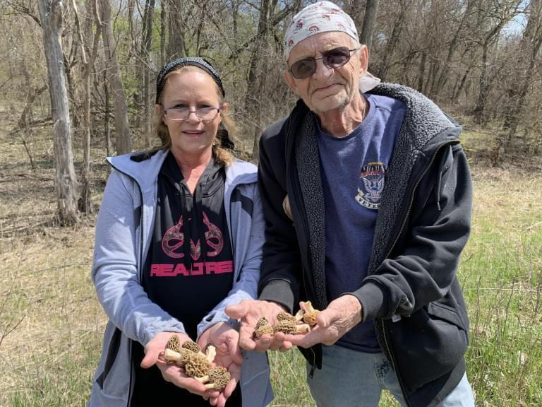 Wendy Porter and her father Roger Jensen show off the morel mushrooms they found in the woods.