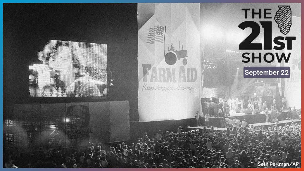 John Cougar Mellencamp performs both on stage and on one of two large screen television screens set up at the University of Illinois Memorial Stadium in Champaign, Ill. on Sept. 22, 1985 during the Farm Aid concert. 