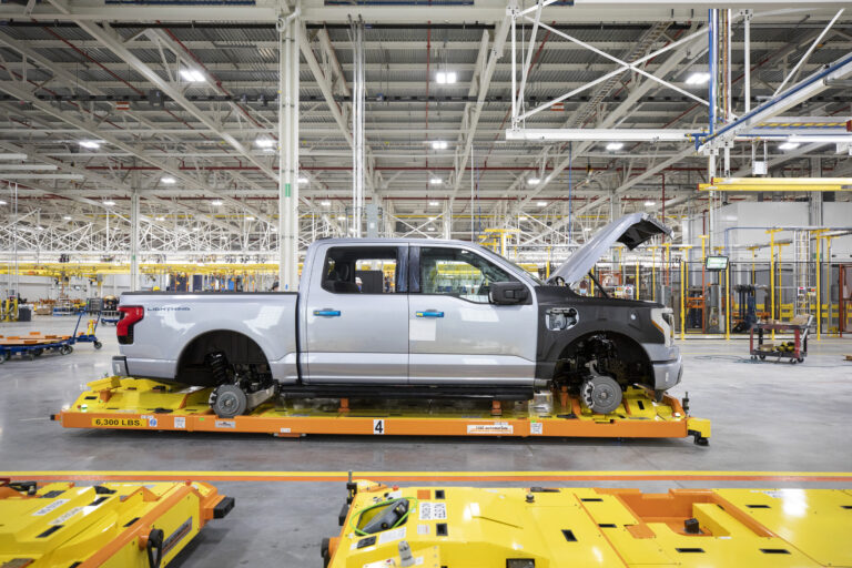 An F-150 Lightning is assembled at Ford's Rogue Electric Vehicle Center in Dearborn, Michigan. The company stopped bookings for the electric pickup at about 200,000 reservations and has increased production estimates to meet demand.