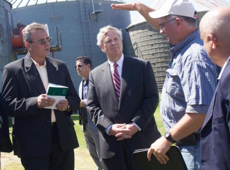 U.S. Secretary of Agriculture Tom Vilsack (center) and Cuban Agriculture Minister Gustavo Rodriguez Rollero (left) listen to Iowa farmer Aaron Lehman during a tour of Lehman's farm in 2016.