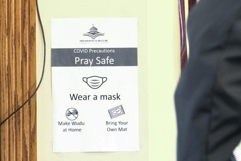 Signs are posted at Masjid Al-Fajr in Indianapolis to remind worshippers of COVID-19 precautions while praying.