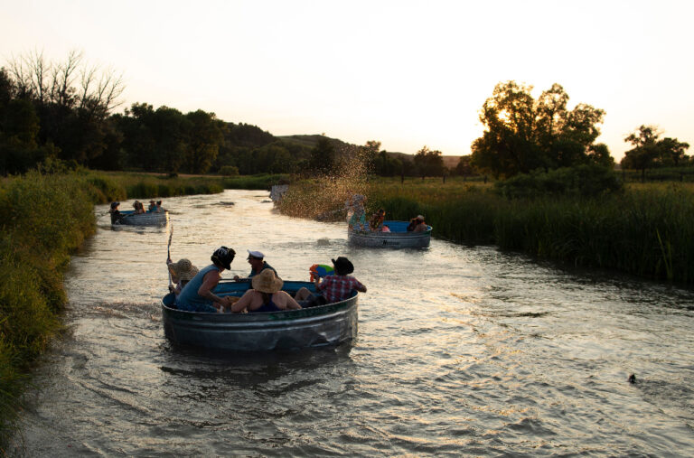 A group floats down the Middle Loup River in Nebraska in livestock water tanks. The state is promoting what locals call 
