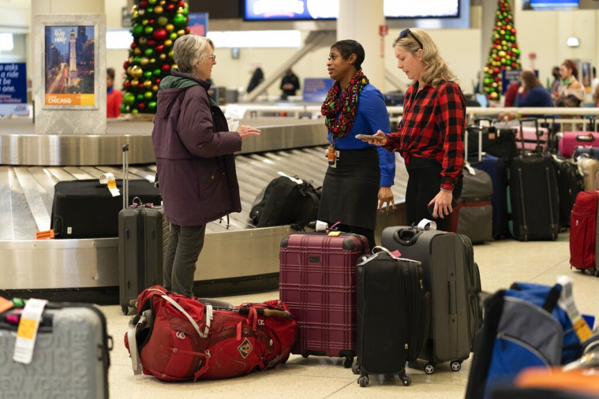 A Southwest Airlines employee helps travelers search for bags at Midway International Airport in this file photo from December 28, 2022.