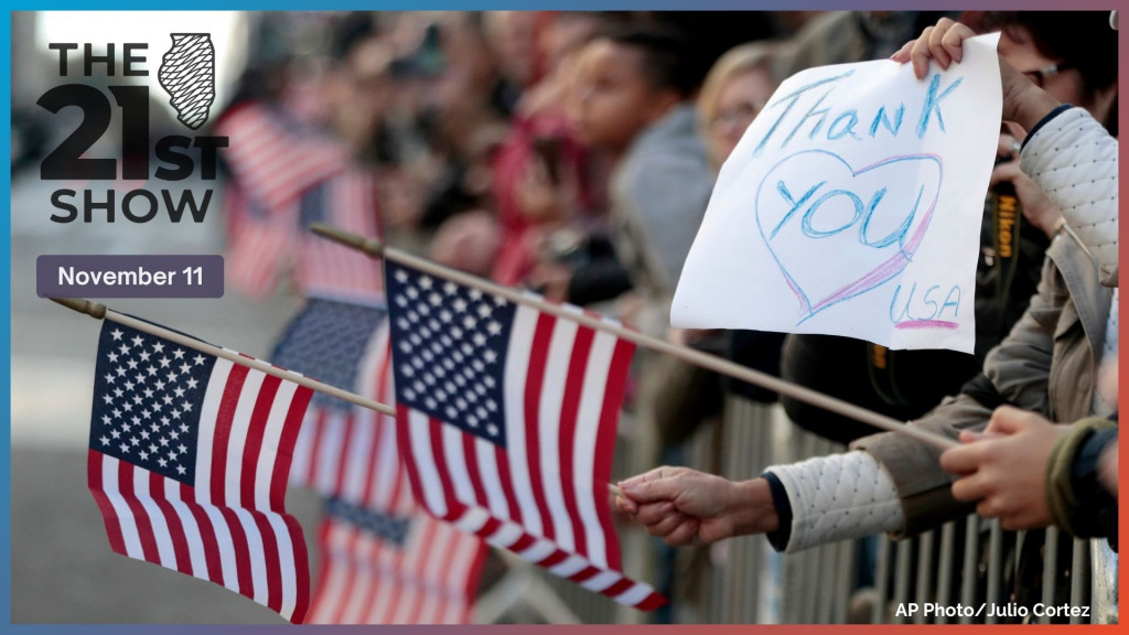 People wave U.S. flags during the Veterans Day parade, Friday, Nov. 11, 2016, in New York. 