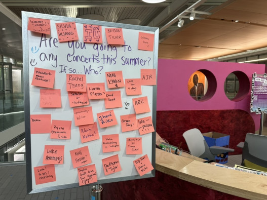 On a white board in the Siebel Center for Design, people had the opportunity to use post-it notes to write down the names of different artists they are seeing this summer. 