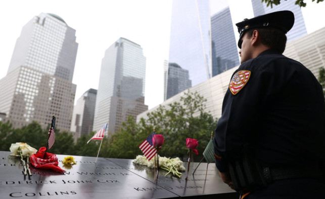 Police officer giving his respects at the 9/11 Memorial in New York City 