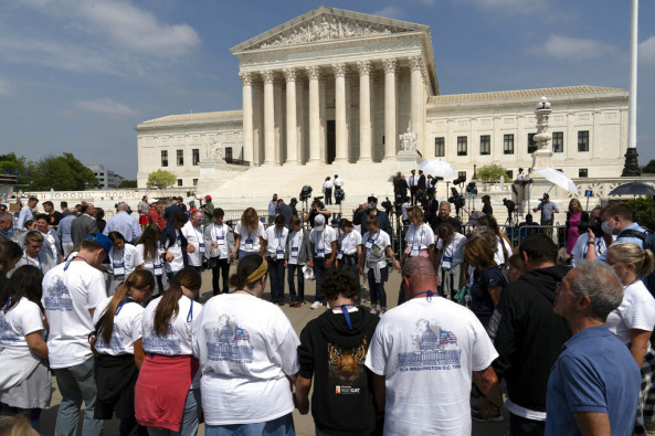 People pray outside of the U.S. Supreme Court Tuesday, May 3, 2022 in Washington. A draft opinion suggests the U.S. Supreme Court could be poised to overturn the landmark 1973 Roe v. Wade case that legalized abortion nationwide, according to a Politico report released Monday. Whatever the outcome, the Politico report represents an extremely rare breach of the court's secretive deliberation process, and on a case of surpassing importance.