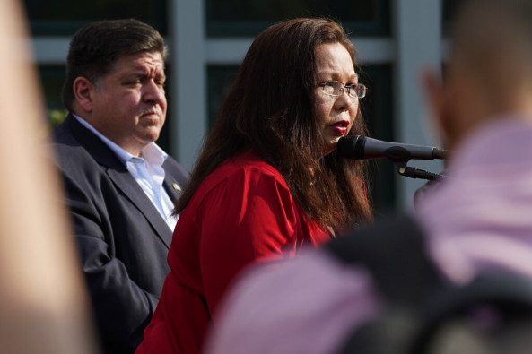 Sen. Tammy Duckworth, right, D-Ill., speaks as Illinois Gov. J.B. Pritzker listens at a news conference at Highland Park Fire Department Station 33., after a mass shooting at the Highland Park Fourth of July parade in downtown Highland Park, a Chicago suburb, on Monday, July 4, 2022.