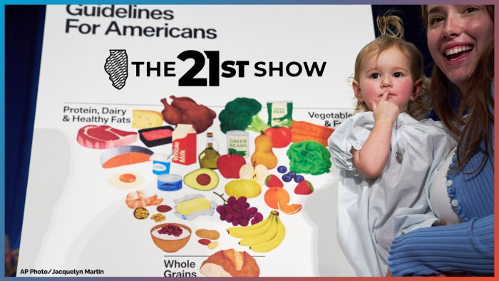 Elle, 18 months, and her mother Claire Dooley stands by the revised food pyramid, after an announcement by Health and Human Services Secretary Robert F. Kennedy Jr., about nutrition policy, at Health and Human Services Headquarters, Thursday, Jan. 8, 2026, in Washington. 