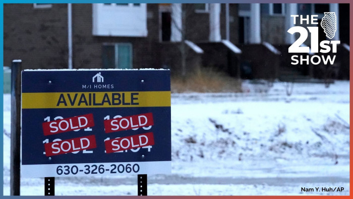 An advertising sign for building land stands in front of a new home construction site in Northbrook, Illinois in this file photo from December 2021.