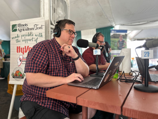 Brian Mackey, host of The 21st, speaking with guests live at the Illinois State Fair 