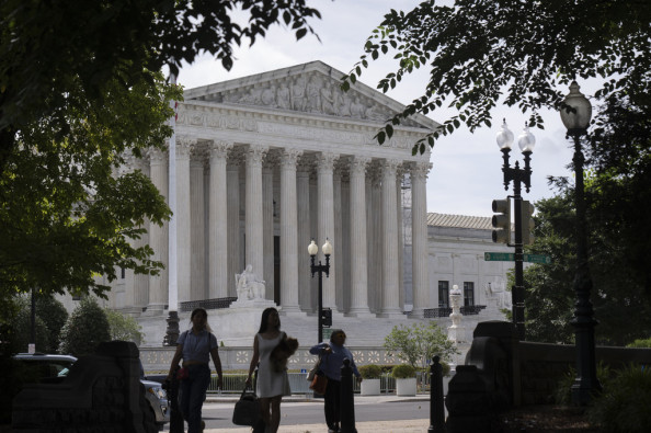 People walk past the Supreme Court in Washington.
