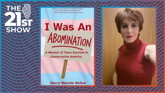 a person with white skin color and brown hair in a bob style wears dark eye makup and red lipstick with a sleeveless red turtleneck sweater; the selfie photo is framed in such a way that tattoos are just barely visible on both arms