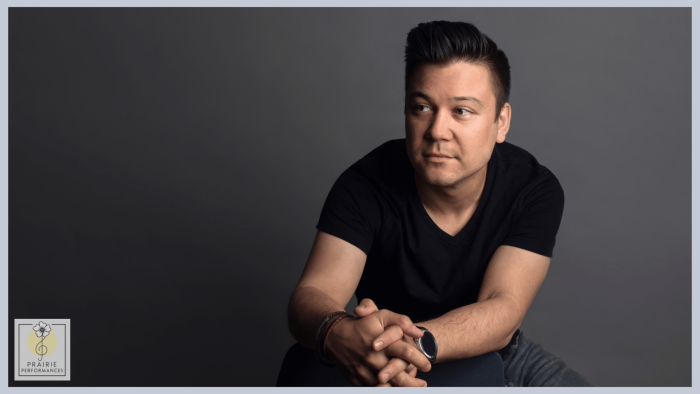 Tim Corpus sitting with his hands folded. 