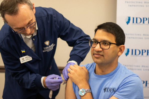 Director of the Illinois Department of Public Health, Sameer Vohra, getting his flu shot immediately after getting his COVID shot on November 8, 2023 in Champaign.
