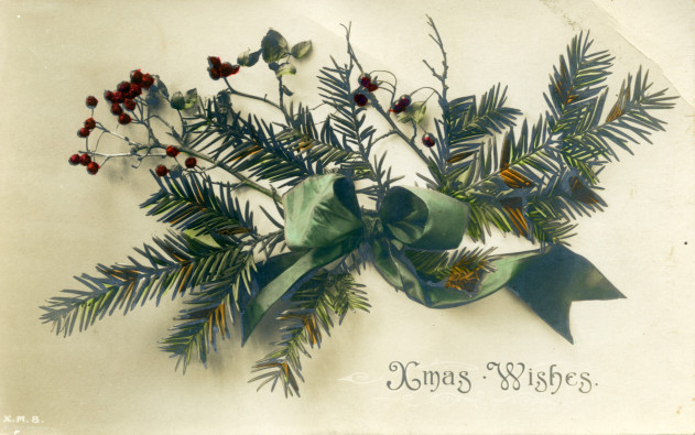  A Christmas card showing a bough of pine needles tied with a green ribbon. The card reads 