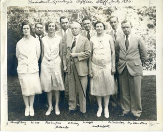 A group of men and women stand together in a line