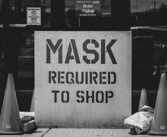 A sign warns visitors to mask before entering the Menards in Morris, Illinois, in June 2020.