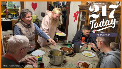 Penny Gioja (left) serves up spaghetti for the Ivashkevych family, who lived at their home in Champaign for several months after they first arrived to the U.S. from Ukraine in September 2024.