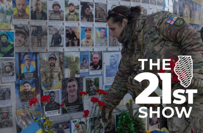 A serviceman mourns at the Memorial Wall of Fallen Defenders of Ukraine in Russian-Ukrainian War in Kyiv, Ukraine, Monday, Feb. 24, 2025.