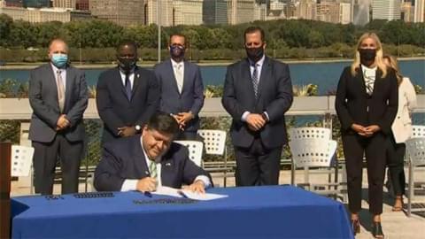 Gov. JB Pritzker signs Senate Bill 2408, a sweeping energy regulation overhaul, into law at the Shedd Aquarium in Chicago Wednesday.