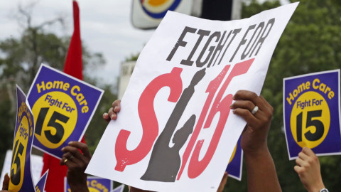In this Sept. 14, 2014, file photo, protesters participate in a rally on Chicago's south side as labor organizers escalate their campaign raise the minimum wage for employees to $15 an hour.