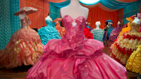 A shopper looks at Quinceañera dresses at a shop on Tuesday, Sept. 9, 2014, in Los Angeles. Quinceañera is a Latin American tradition to celebrate a girl's 15th birthday.