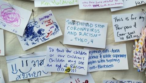 Messages are posted in a wall of solidarity by people participating at a rally "Love Our Communities: Build Collective Power" to raise awareness of anti-Asian violence outside the Japanese American National Museum in Little Tokyo in Los Angeles Saturday, March 13, 2021.