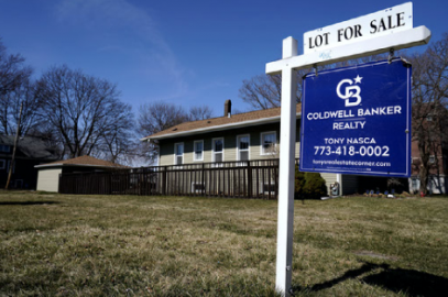 A "lot for sale" sign stands along side a housing lot in Des Plaines, Ill., Sunday, March 21, 2021. U.S. long-term mortgage rates continued to edge higher this week as the benchmark 30-year loan stayed above the 3% mark. Rates remain near historic lows, however.