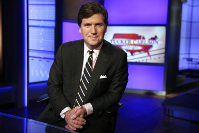 In this March 2, 20217, file photo, Tucker Carlson, host of "Tucker Carlson Tonight," poses for photos in a Fox News Channel studio in New York.