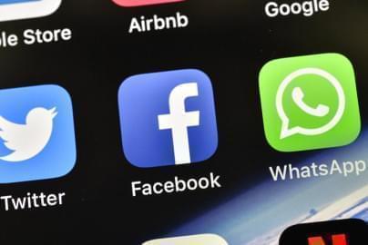  In this Nov. 15, 2018 file photo, the icons of Facebook and WhatsApp are pictured on an iPhone.