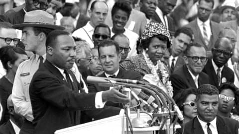 The Rev. Dr. Martin Luther King Jr., delivers his "I Have a Dream" speech in Washington, Aug. 28, 1963, as National Park Service ranger Gordon "Gunny" Gundrum, left, stands beside King. 