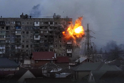 An explosion is seen in an apartment building after Russian's army tank fires in Mariupol, Ukraine, Friday, March 11, 2022