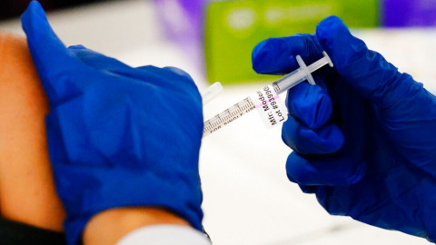 A health worker administers a dose of a Moderna COVID-19 vaccine during a vaccination clinic at the Norristown Public Health Center in Norristown, Pa., Tuesday, Dec. 7, 2021.