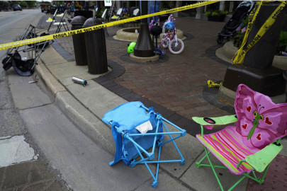 Empty chairs, a bicycle and a stroller are seen after a mass shooting at the Highland Park Fourth of July parade in downtown Highland Park, Ill., a Chicago suburb on Monday, July 4, 2022.