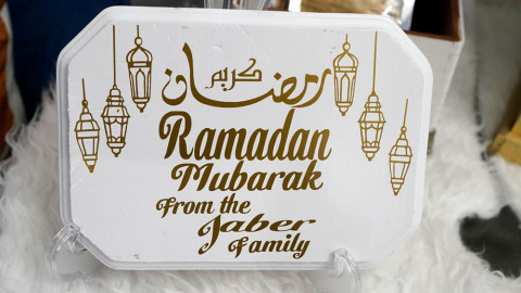 A Ramadan sign created by Suzanne Jaber of The Eid Shop is displayed in Dearborn Heights, Mich., on Monday, March 27, 2023. More businesses are selling Ramadan and Eid items, including DIY kits, lanterns and napkin holders. She began crafting and selling her own dedicated Ramadan and Eid decorations and now ships items across the U.S. and world.