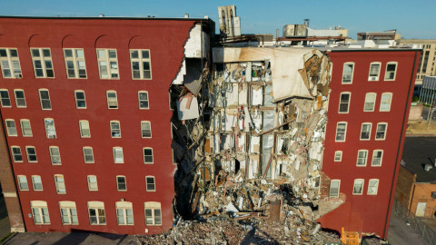 An apartment building that partially collapsed two days earlier can be seen Tuesday, May 30, in Davenport, Iowa. Five residents of the six-story apartment building remained unaccounted for and authorities fear at least two of them might be stuck inside rubble that was too dangerous to search.