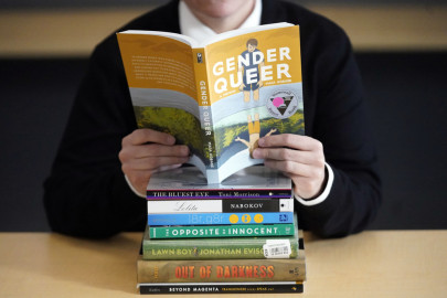 A pile of challenged books appear at the Utah Pride Center in Salt Lake City on Dec. 16, 2021. Book challenges at school and public libraries continue to surge, according to a report from the American Library Association.