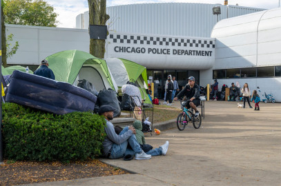 Asylum-seekers, mostly from Venezuela, hang out in front of an encampment outside the Chicago Police District 3 station in the Woodlawn neighborhood. The nonprofit International Institute of St. Louis is partnering with unions and philanthropic leaders to resettle hundreds of migrants in their city.