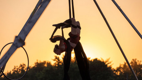 circus performer in front of sunset