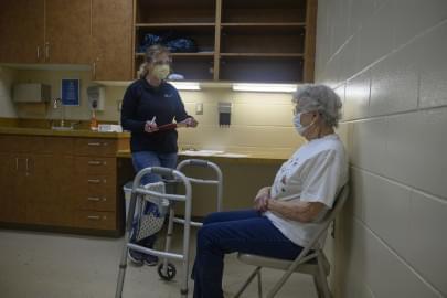 Nurse Tammy Miller asks Beverly Gerard, 92, of Beverly, Iowa, questions before administering her first dose of the Moderna COVID-19 vaccine on Feb. 1. Gerard secured an appointment at the Tama County Public Health Department clinic through her niece.