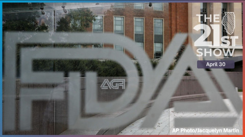 File photo shows the U.S. Food and Drug Administration building behind FDA logos at a bus stop on the agency's campus in Silver Spring, Md.