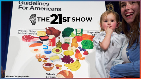 Elle, 18 months, and her mother Claire Dooley stands by the revised food pyramid, after an announcement by Health and Human Services Secretary Robert F. Kennedy Jr., about nutrition policy, at Health and Human Services Headquarters, Thursday, Jan. 8, 2026, in Washington. 