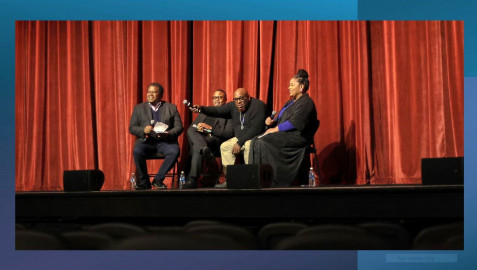 Left to right: Reginald Hardwick, IPM News & Public Affairs Director; Dr. Leonard McKinnis, UIUC professor of African American religions and Black studies; musician Aaron Wilson, pointing his mic to the crowd for call and response; and Dr. Malaika McKee, UIUC professor in the College of Education.