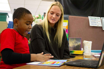 Second grader Calvin Cowen practices reading with teaching assistant Kelsey Martlage at Meade Park Elementary School in Danville on January 26, 2024.